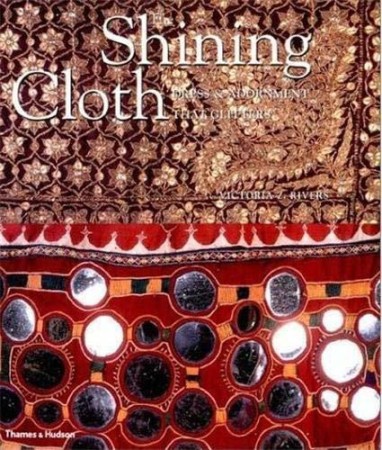 First  cover of 'THE SHINING CLOTH. DRESS & ADORNMENT THAT GLITTERS.'